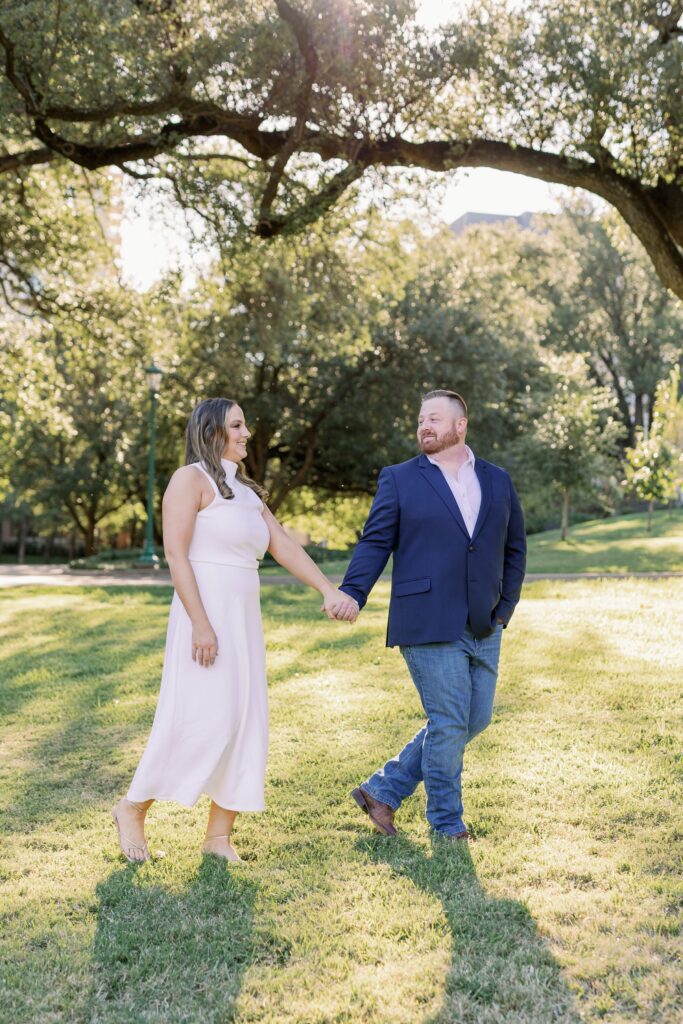Couple walking through the lawn at Arlington Hall with trees in the background